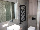 Фотография ремонта душевой с оригинальным полотенцесушителем в ЖК Новопечереские липки