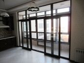 Фото после ремонта на кухне с видом на город в жилом комплексе 